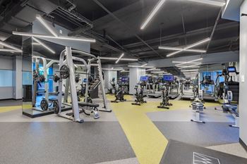 a gym with weights and cardio equipment in a building at The Citizen at Shirlington Village in Arlington, VA 22206